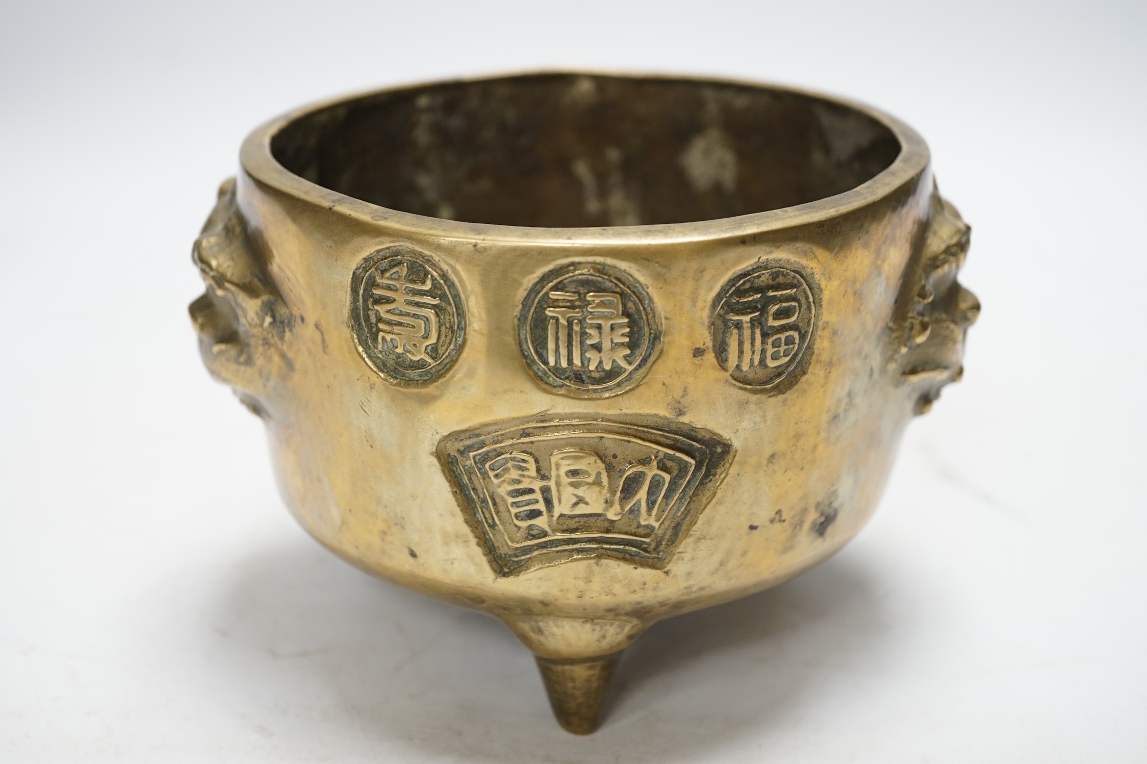 A Chinese bronze tripod censer, 18cm. Condition - fair to good
